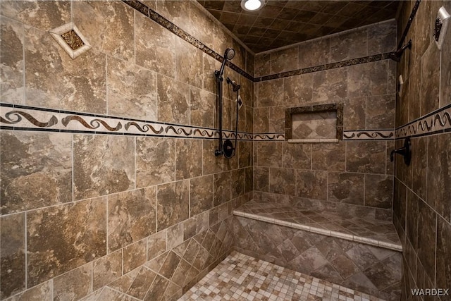 bathroom with tiled shower