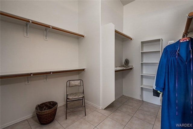 spacious closet with light tile patterned floors