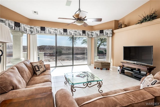 living room featuring light tile patterned floors, visible vents, and a ceiling fan