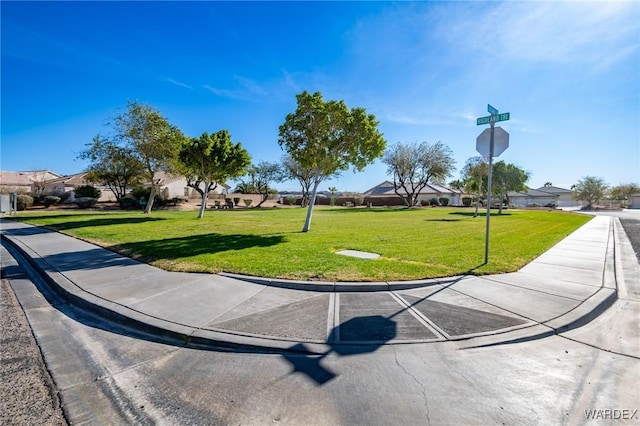 view of community with a residential view and a yard