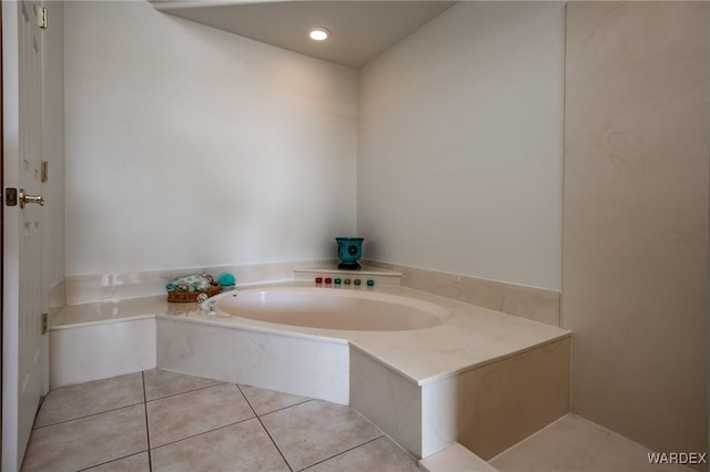 bathroom with tile patterned flooring and a bath