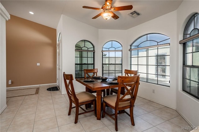 dining area with baseboards, visible vents, a ceiling fan, and light tile patterned flooring