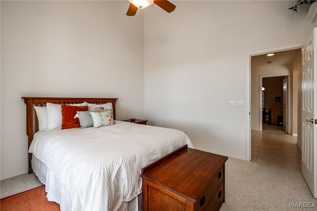 bedroom featuring ceiling fan, light colored carpet, and baseboards