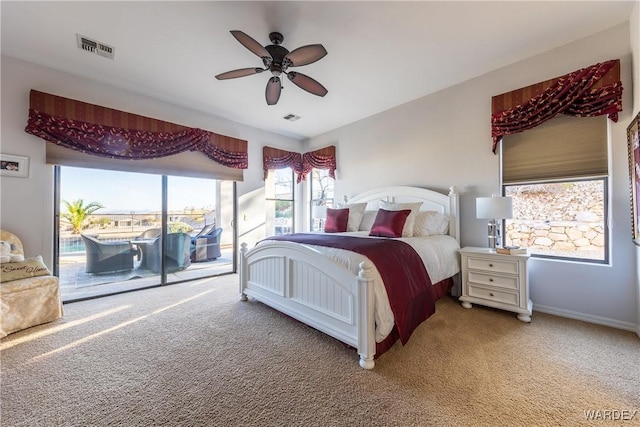 bedroom featuring access to exterior, visible vents, and light carpet