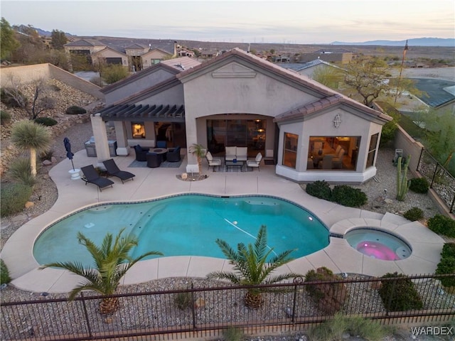 view of swimming pool featuring a fenced in pool, an in ground hot tub, fence private yard, a patio area, and an outdoor living space with a fireplace