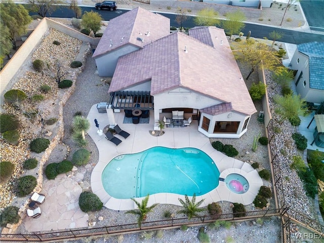 view of pool featuring a fenced in pool, a patio area, outdoor dry bar, and a fenced backyard