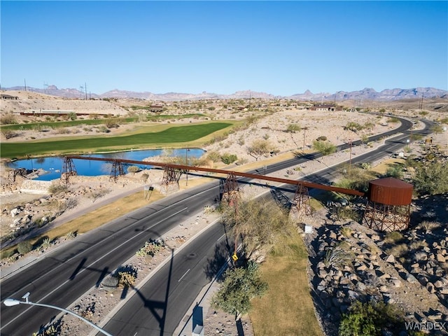 drone / aerial view with a water and mountain view