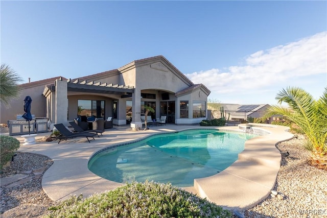 outdoor pool with fence, area for grilling, and a patio