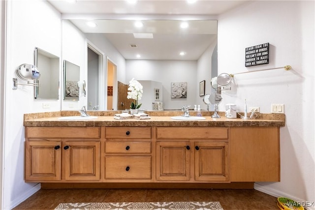 full bathroom featuring double vanity, visible vents, a sink, and recessed lighting