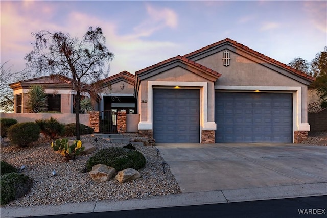 view of front of property with a garage, a tiled roof, concrete driveway, and stucco siding