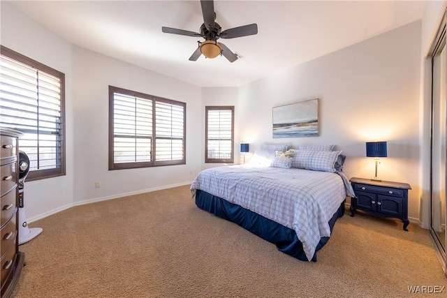 bedroom featuring baseboards, a ceiling fan, and light colored carpet