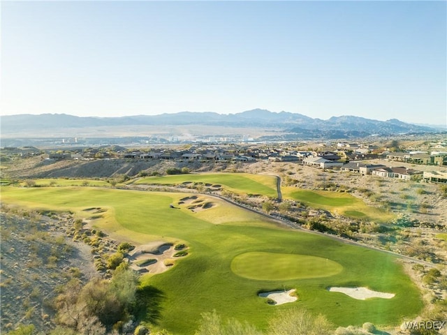 drone / aerial view with golf course view and a mountain view