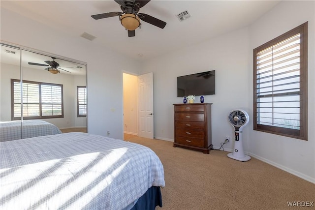 bedroom with light carpet, baseboards, visible vents, and ceiling fan