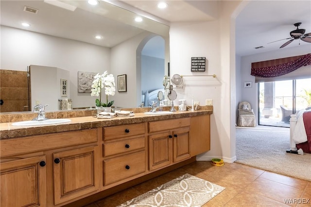 full bathroom featuring double vanity, visible vents, a sink, and tile patterned floors