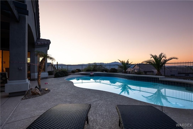 view of swimming pool featuring a mountain view, a patio area, fence, and a fenced in pool