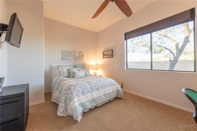 bedroom with baseboards, a ceiling fan, and light colored carpet