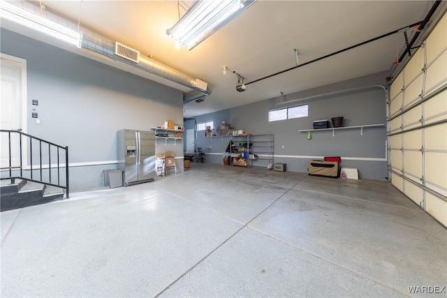 garage featuring visible vents and a garage door opener