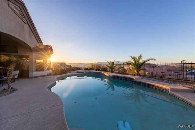 view of swimming pool featuring a patio, fence, and a fenced in pool