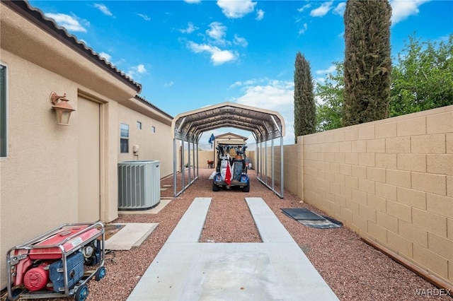 view of patio / terrace with central air condition unit, a detached carport, and fence