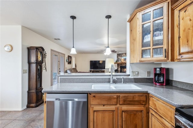 kitchen with a peninsula, stainless steel dishwasher, a sink, light tile patterned flooring, and visible vents