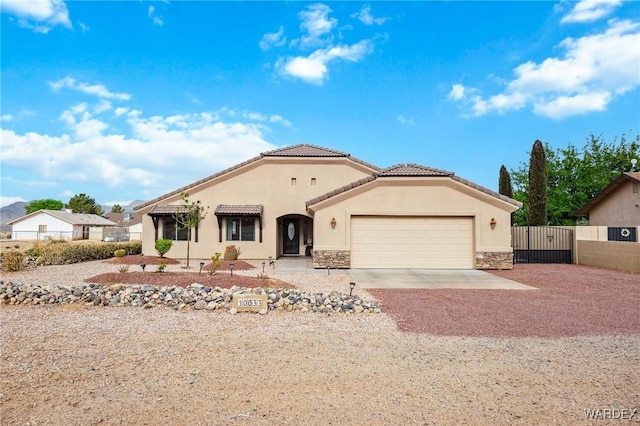 single story home with a gate, an attached garage, driveway, and fence