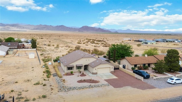 aerial view featuring a rural view, a desert view, and a mountain view