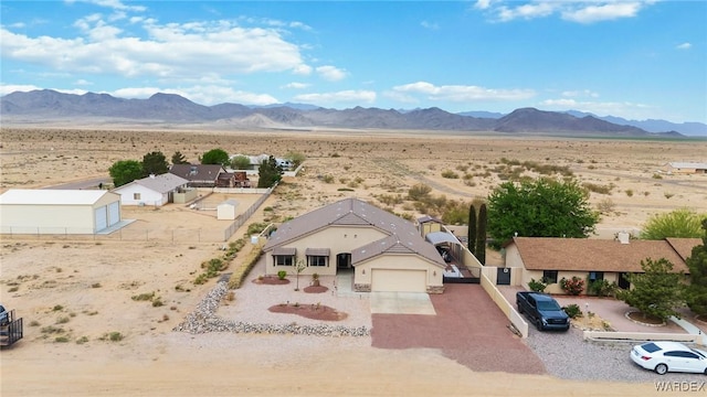 birds eye view of property featuring a rural view, a desert view, and a mountain view
