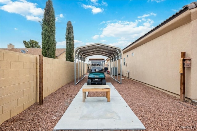 exterior space with fence and a detached carport