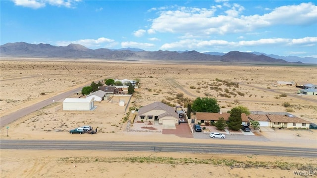 birds eye view of property featuring view of desert, a rural view, and a mountain view