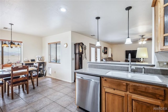 kitchen with a sink, visible vents, brown cabinets, dishwasher, and light tile patterned floors