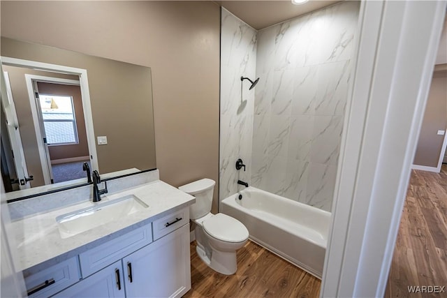 bathroom with shower / washtub combination, vanity, toilet, and wood finished floors