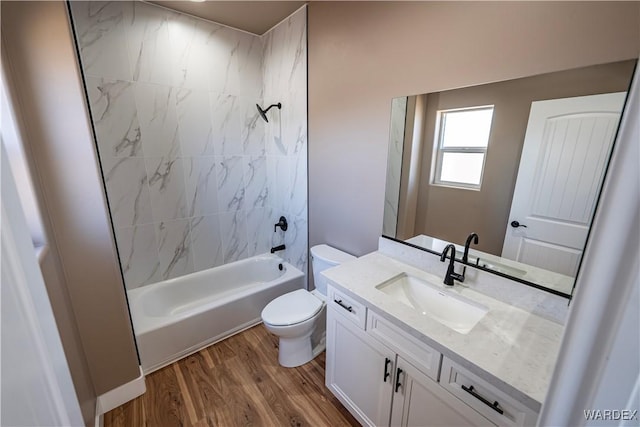 full bath featuring vanity, bathtub / shower combination, wood finished floors, and toilet