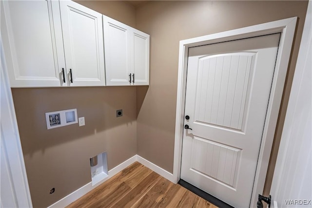 washroom with hookup for a washing machine, light wood-style floors, baseboards, cabinet space, and electric dryer hookup