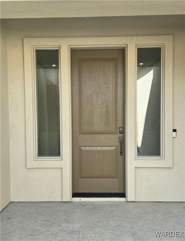 property entrance with stucco siding