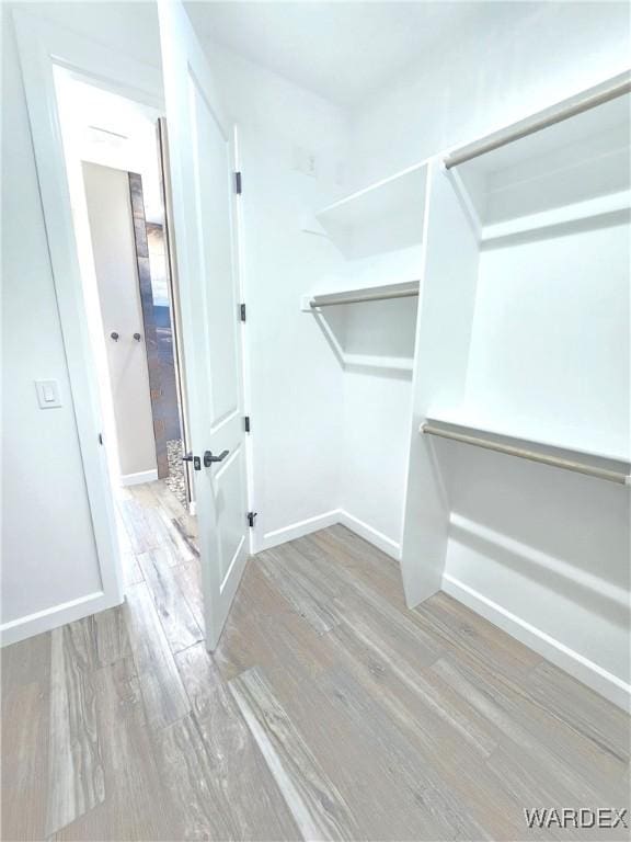 spacious closet with wood finished floors