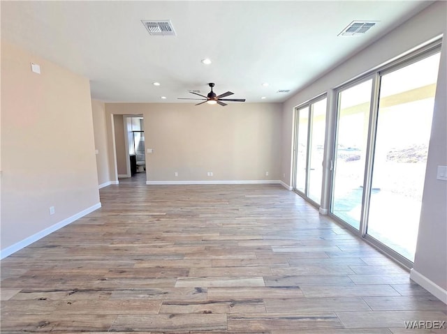 spare room featuring recessed lighting, baseboards, visible vents, and light wood finished floors