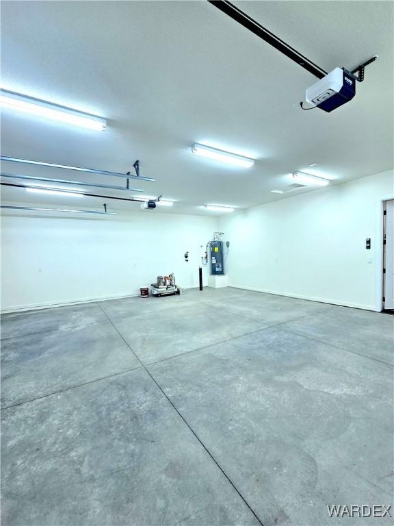 garage with water heater and a garage door opener