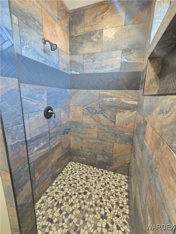 full bath featuring a tile shower