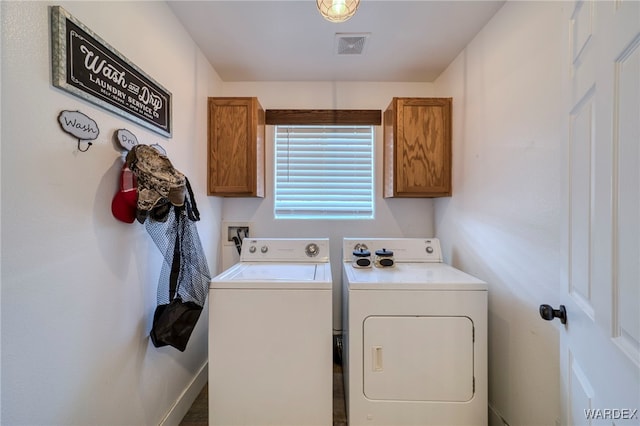 laundry room with visible vents, washer and clothes dryer, and cabinet space