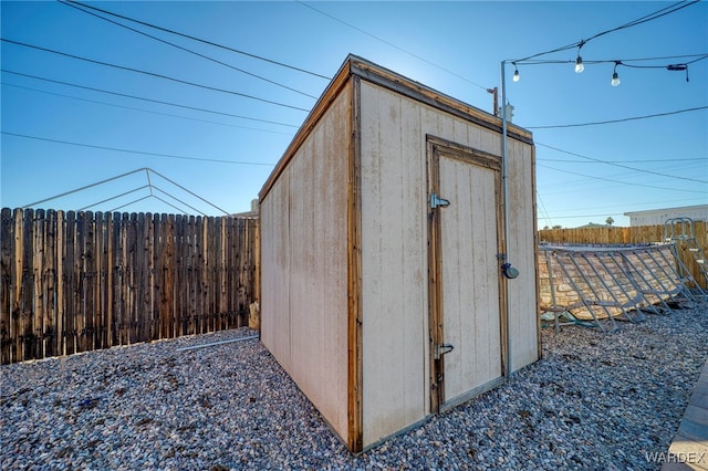 view of shed featuring fence