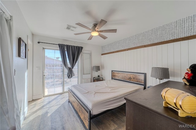 bedroom with ceiling fan, light wood-style flooring, visible vents, and access to exterior