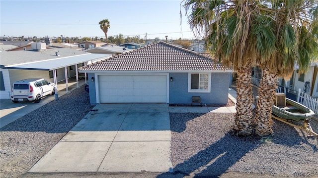 view of front of property with a tile roof, driveway, an attached garage, and stucco siding