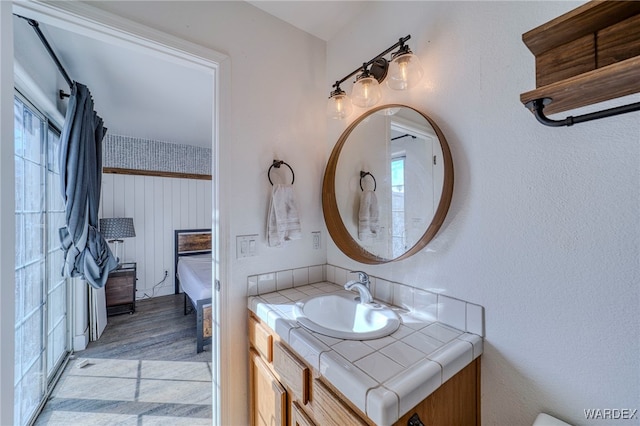 half bathroom with vanity and wood finished floors