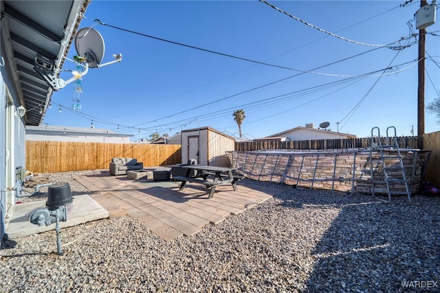 view of yard featuring an outbuilding, a fenced backyard, a patio, and a storage shed