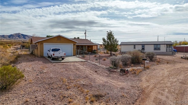 ranch-style house featuring fence and a mountain view