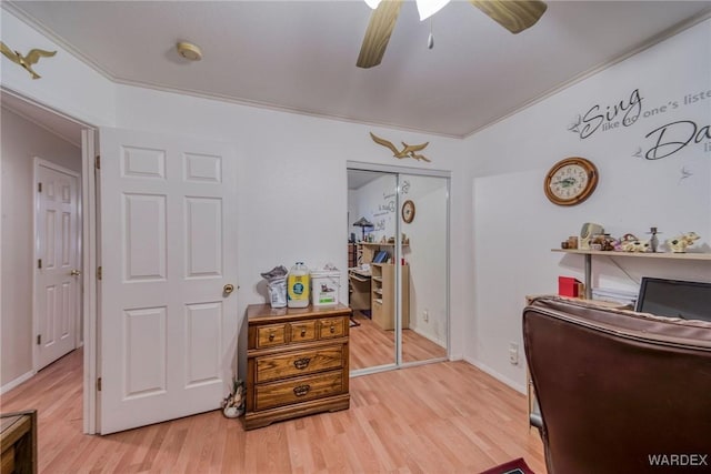 office featuring ceiling fan, ornamental molding, and light wood-style flooring