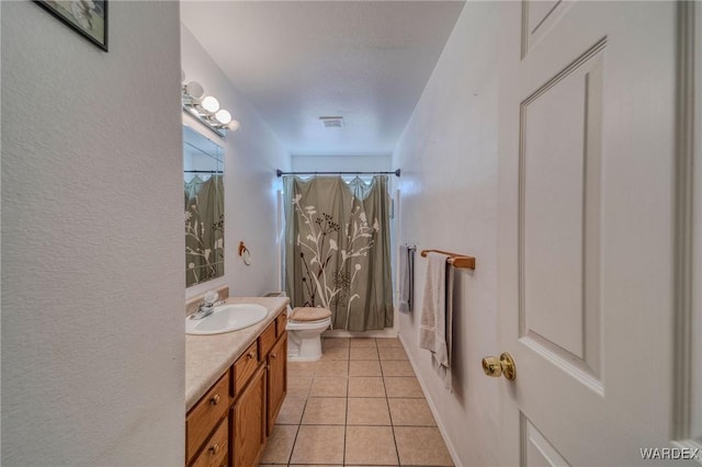 bathroom with toilet, tile patterned floors, shower / bath combination with curtain, and vanity