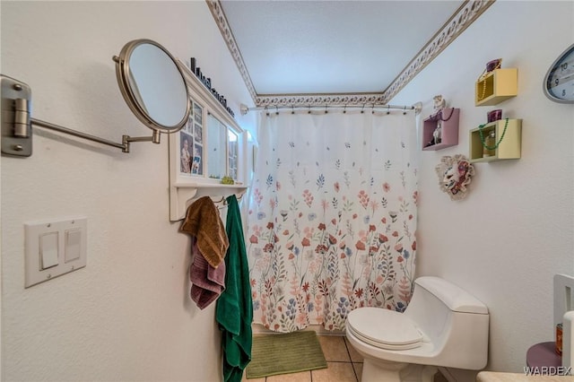 bathroom with a shower with curtain, toilet, and tile patterned floors