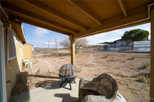 view of patio / terrace with an outdoor fire pit and fence