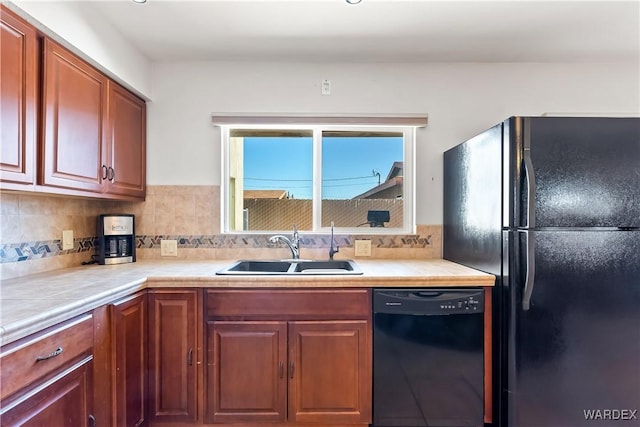 kitchen featuring decorative backsplash, a sink, and black appliances